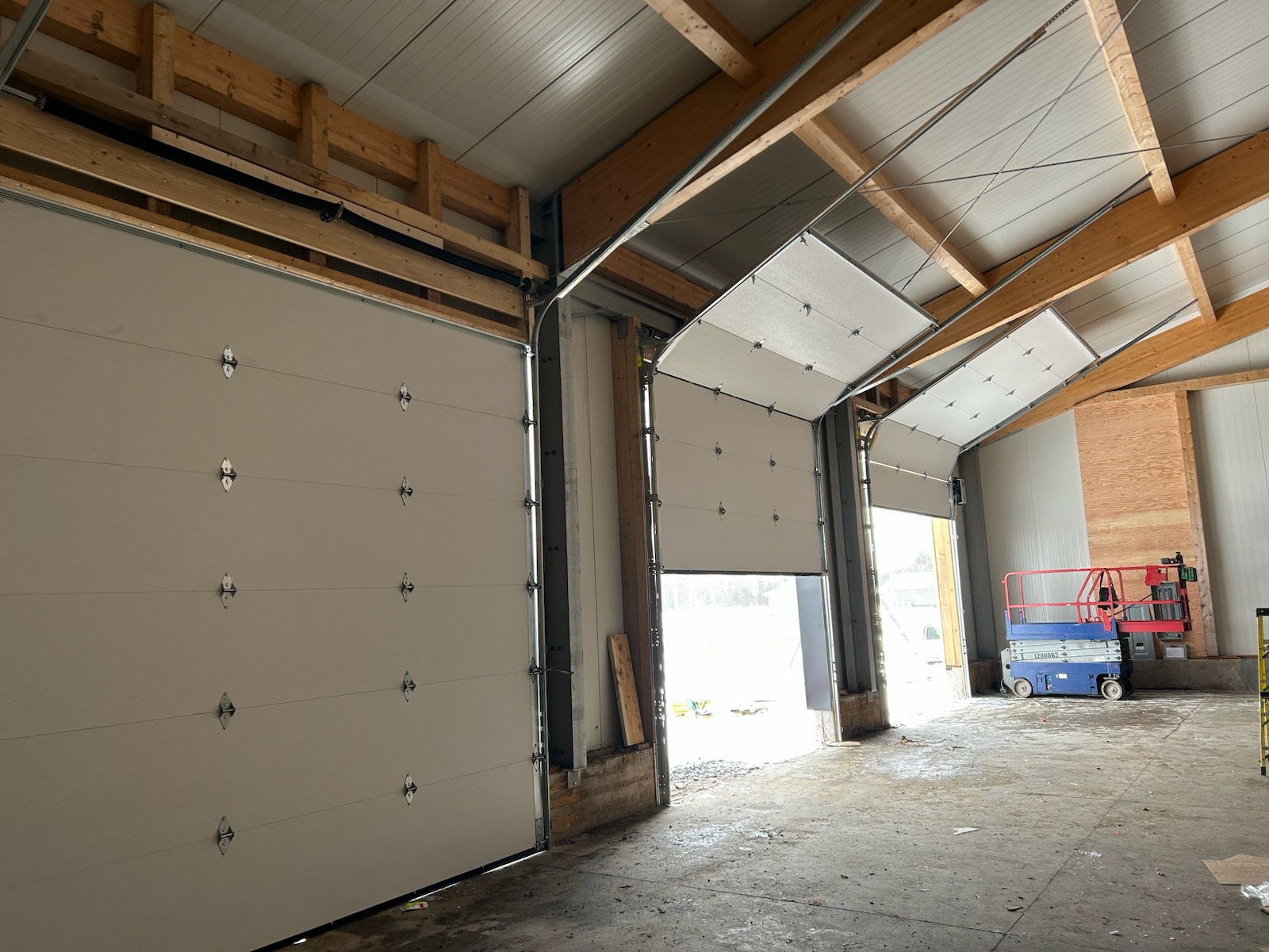 White overhead garage door installed inside a garage bay